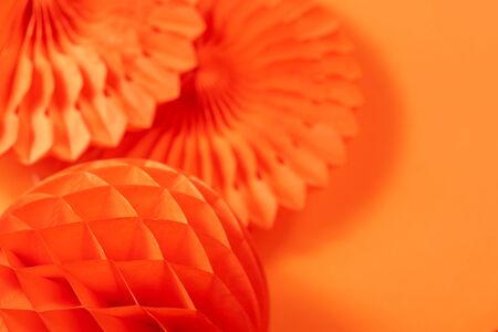 paper fans and honeycombs on the orange backgroundの写真素材