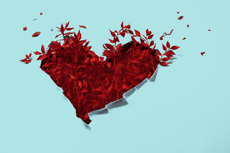 Valentine heart red branches with painted leaves in paper hole