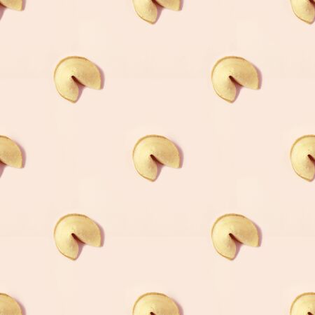 fortune cookie on pastel pink backgroundの写真素材
