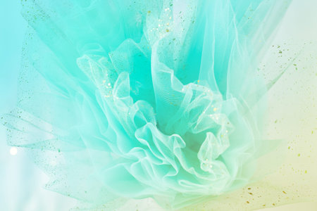 Feminine turquoise fabric tutu tulle skirt close up texture background with golden glitter