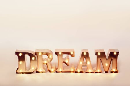 Close up of decorative letters lining word dream glowing with lightsの写真素材