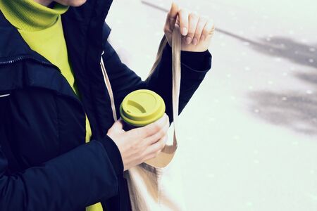 Female hands hold reusable coffee mug. Take your coffee to-go with reusable mug.の写真素材