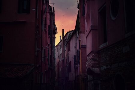 Evening canal scene at sunset, Venice, Italy. Romantic dark and vibrant cityscape. Travel and exploreの写真素材