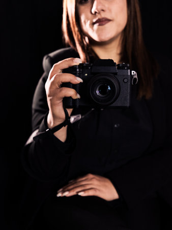 woman photographer close up camera black backgroundの写真素材