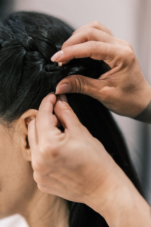 Hair stylist working in a salon. Close up to handsの写真素材