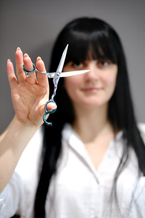 Hair stylist working in a salon. Close up to handsの写真素材