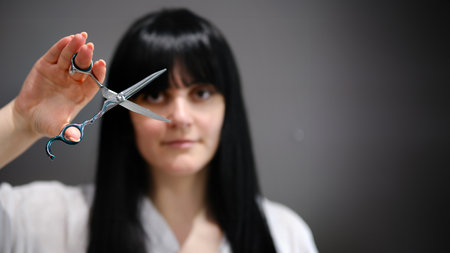 Hair stylist working in a salon. Close up to handsの写真素材
