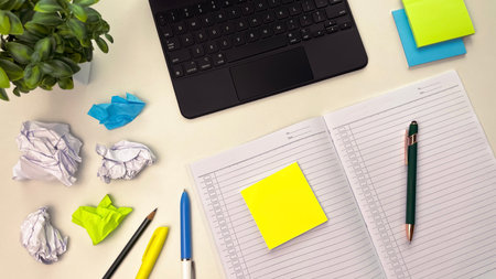 A photo of a planner, laptop, brightly colored sticky notes, and stationery. Concept of scheduling, productivity, and time management.の写真素材