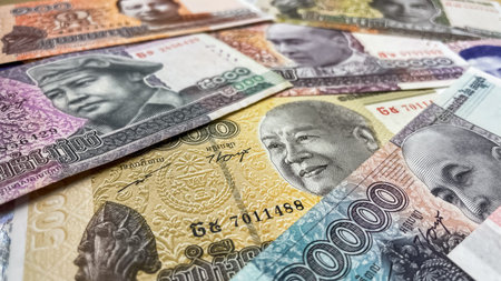 A close-up of various Cambodian riel banknotes laid out on a surface. Concept of finance, economics,...