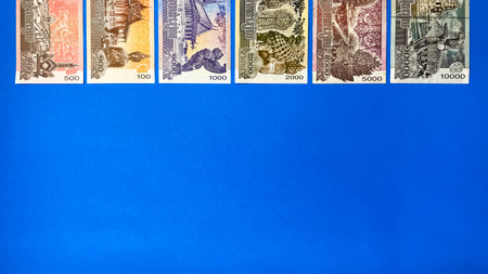 Various Cambodian banknotes are arranged in a row at the top of the image against a blue background. Conceptually, this depicts money, finance,の写真素材