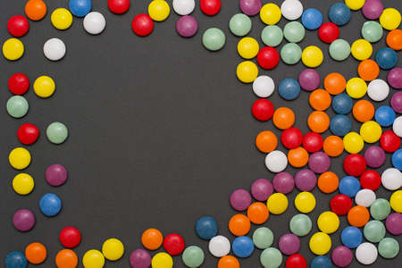 Multicolored candy and lollipops on a gray background.の写真素材