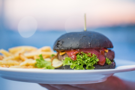 Black hamburger with French friesの写真素材
