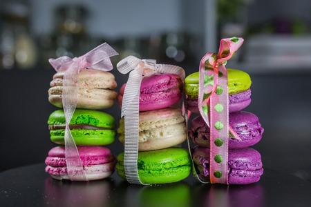 Macarons tied with ribbons of three pieces, a French dessert, gifts for the holidayの写真素材