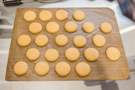 Macaroon on parchment ready for baking, french dessert, top view