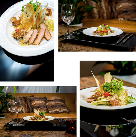 Buffet table is served with delicious dishes. Meat, seafood, a salad Stuffed vegetables and cream cheese, garnished with greenery.の写真素材