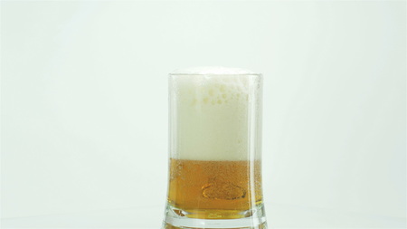 Cold mug of beer with foam.の写真素材