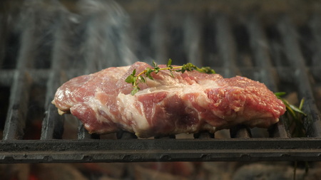 A juicy piece of choice beef, veal or lamb roasted on the grill with a haze and a twig of grilled wood in the kitchen of the restaurant, delicatessen.の写真素材