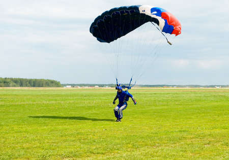 Landing of the videotape operator after parachute jumpの写真素材