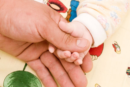 The child holds by the hand the father