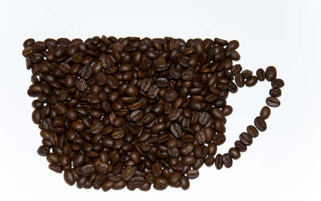 Silhouette of a cup from coffee grains on a white backgroundの写真素材
