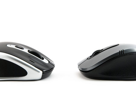 Two computer mouse of dark blue color on a white background