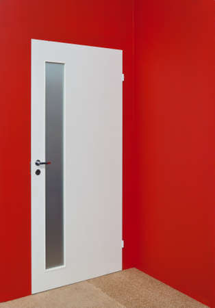 White door and red wallの写真素材