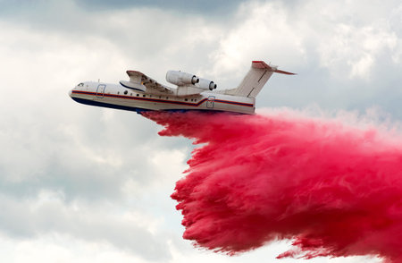 Flying aerial firefighting pour water over the fire