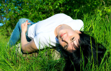 The girl curved a back lying on a stoneの写真素材