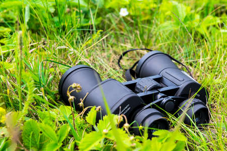 close-up of binoculars on green grassの写真素材