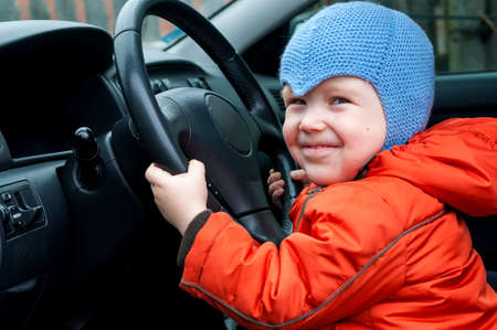 boy sitting in the car as the driverの写真素材