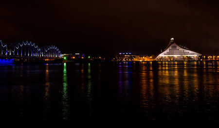 Railway bridge and buildings in Riga at night