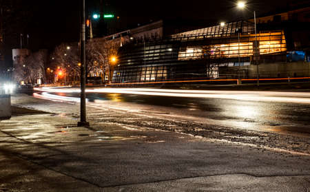 An empty highway in a fog at night. Street Lights close-up, motion blur effect, long exposure. Dark urban scene, cityscape.の写真素材
