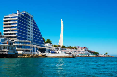 Sevastopol, Crimea, Russia - June 11, 2021: Residential complex Cape Khrustalny and the obelisk to the Hero City of Sevastopol during sunny dayのeditorial素材