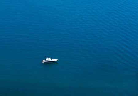 Amazing view to Yacht sailing in open sea at calm day. Drone view - birds eye angle. Yachting theme