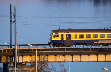 Riga, Latvia - April 22, 2019: Electric train passing the bridge over Daugava in Riga, Latviaのeditorial素材