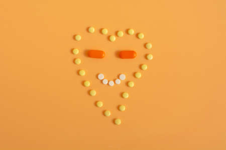 pills in the form of a heart with a smile. Medicine and good mood conceptの写真素材