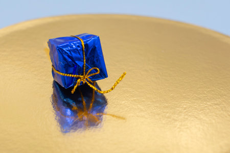 small blue gift box with gold ribbon. The concept of the holiday.の写真素材