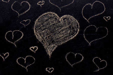 White color chalk hand drawing in heart shape on blackboard background.valentine's dayの写真素材