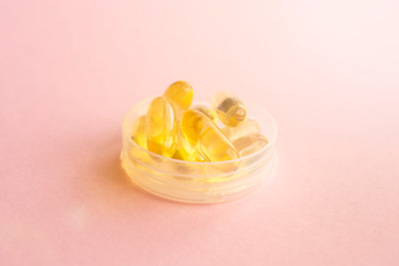 Fish oil capsules with omega 3 and vitamin D, healthy eating conceptの写真素材