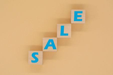 the word SALE written on wooden cubes. The concept of sales and discounts.