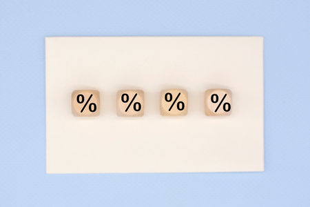 Percent sign on wooden cubes. Business and finance discount or interest rate concept.の写真素材