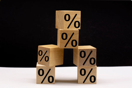 Percent sign on wooden cubes on a black and white background. Business and finance discount or interest rate concept.の写真素材