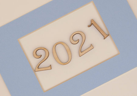wooden numbers 2021 in a blue frame on a light background. The concept of new year