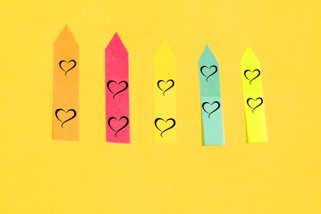 multi-colored stickers, bookmarks, 5 pieces, orange, pink, yellow, green and blue on a background, isolated on a yellowの写真素材