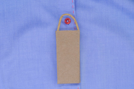 a blue fashion shirt with a red buttons and craft package. The concept of shopping .. Expensive branded shirtsの写真素材