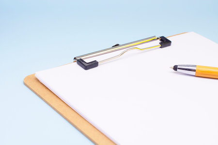 paper with a pen on a blue background. The concept of the transience of time.