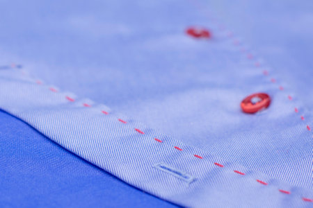 a blue fashion shirt with a red buttons. Expensive branded shirtsの写真素材