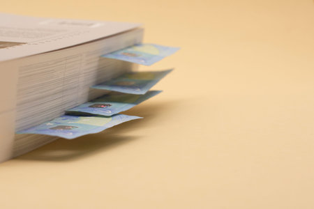 Banknotes of EURO money hidden in a book. Budget Saving. Time to get saved money in times of...