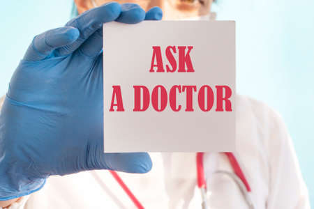 Female doctor holding a tablet with the text: ASK A DOCTORの写真素材