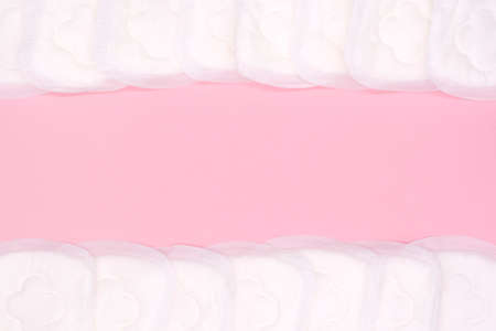 napkin or sanitary pad for intimate hygiene on a pink backgroundの写真素材